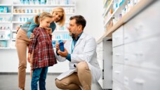 Apotheker auf Augenhöhe mit dem Kind. (Foto:Drazen/AdobeStock)